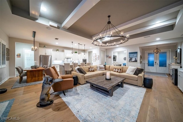 14372 Neptune Ave, Naples, FL 34114 - living room with a chandelier, light wood-style flooring, beam ceiling, recessed lighting, and baseboards