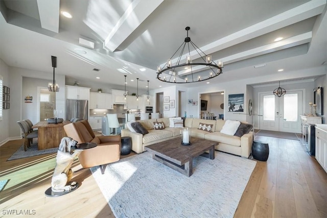 14372 Neptune Ave, Naples, FL 34114 - living area with a chandelier, french doors, wood-type flooring, baseboards, and recessed lighting