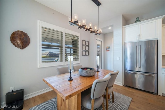 14372 Neptune Ave, Naples, FL 34114 - dining space featuring light wood finished floors, a chandelier, baseboards, and recessed lighting