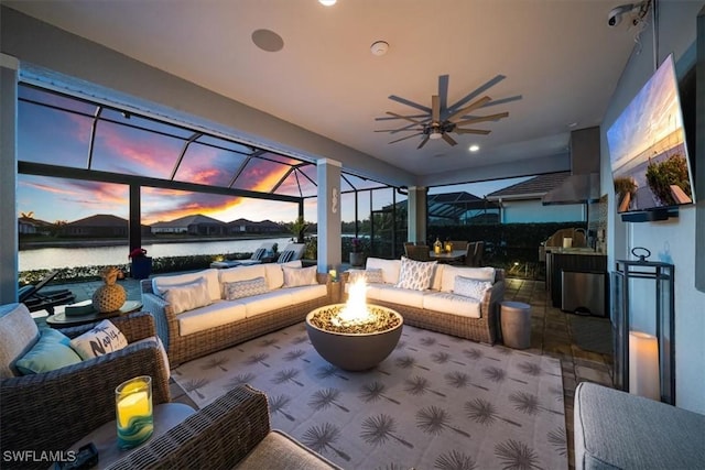 14372 Neptune Ave, Naples, FL 34114 - view of patio featuring an outdoor living space with a fire pit, a water view, glass enclosure, and ceiling fan