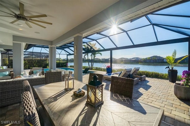 14372 Neptune Ave, Naples, FL 34114 - view of patio with an outdoor hangout area, a lanai, a ceiling fan, an outdoor pool, and a water view