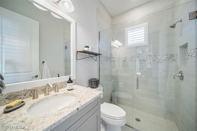 14372 Neptune Ave, Naples, FL 34114 - bathroom with vanity, toilet, and a shower stall