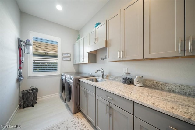 14372 Neptune Ave, Naples, FL 34114 - washroom featuring cabinet space, independent washer and dryer, and baseboards