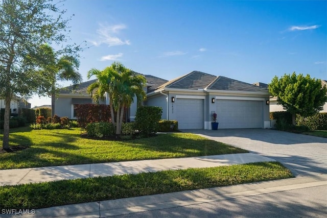 14372 Neptune Ave, Naples, FL 34114 - ranch-style home with an attached garage, a front yard, decorative driveway, and stucco siding