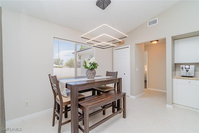 2310 SW 17th St, Cape Coral, FL 33991 - dining area featuring a chandelier, lofted ceiling, baseboards, and light tile patterned floors