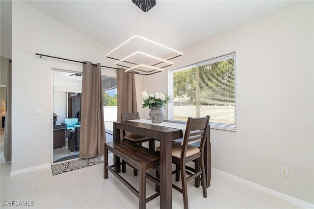 2310 SW 17th St, Cape Coral, FL 33991 - dining space with a chandelier, baseboards, and light tile patterned floors