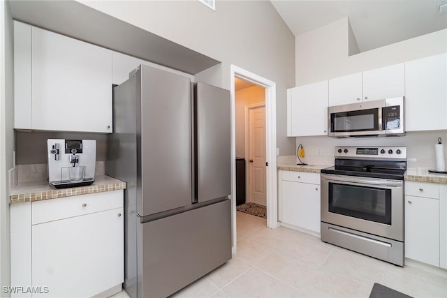 2310 SW 17th St, Cape Coral, FL 33991 - kitchen featuring stainless steel appliances, light countertops, white cabinets, and light tile patterned flooring