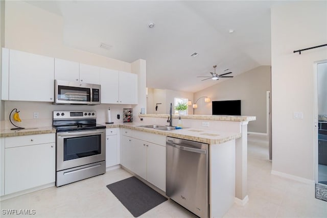2310 SW 17th St, Cape Coral, FL 33991 - kitchen featuring appliances with stainless steel finishes, a sink, a peninsula, light countertops, and white cabinetry