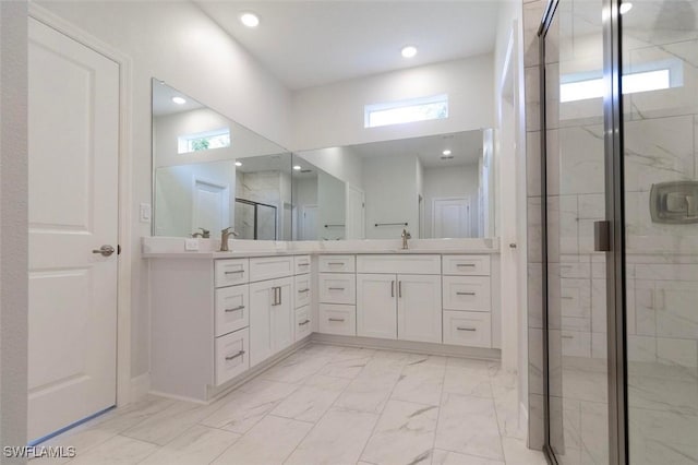 17211 Nile Ct, Punta Gorda, FL 33955 - bathroom featuring marble look tiles, a shower stall, double vanity, plenty of natural light, and recessed lighting