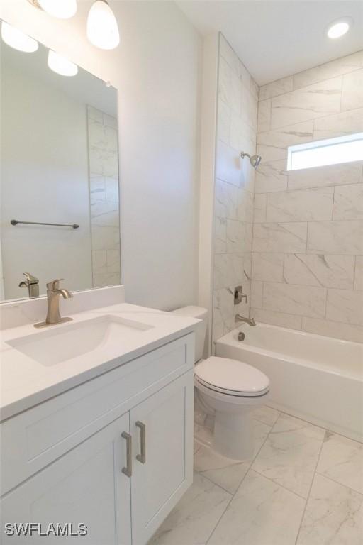 17211 Nile Ct, Punta Gorda, FL 33955 - bathroom with vanity, marble look tiles, toilet, and shower / tub combination