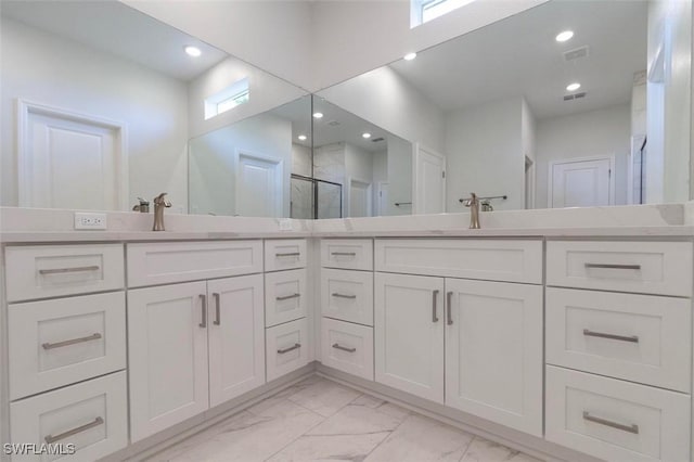 17211 Nile Ct, Punta Gorda, FL 33955 - full bathroom with double vanity, marble finish floors, a shower stall, and recessed lighting
