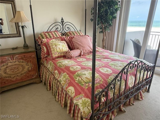 180 Seaview Ct Unit 715, Marco Island, FL 34145 - bedroom with light colored carpet and view of water and beach