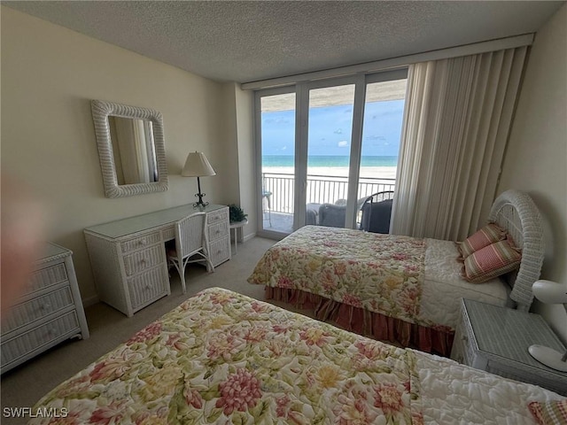 180 Seaview Ct Unit 715, Marco Island, FL 34145 - carpeted bedroom featuring access to exterior, view of water and beach, and a textured ceiling