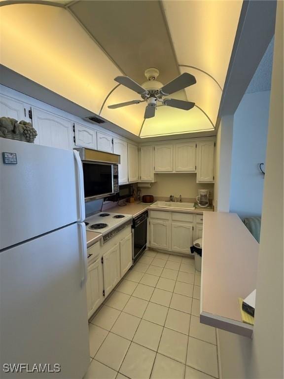 180 Seaview Ct Unit 715, Marco Island, FL 34145 - kitchen featuring black appliances, light tile patterned floors, light countertops, ceiling fan, and white cabinets