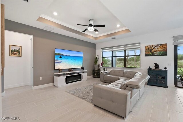 5596 Celebration Dr, Ave Maria, FL 34142 - living room featuring a tray ceiling, ornamental molding, ceiling fan, recessed lighting, and baseboards