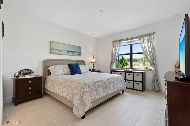 5596 Celebration Dr, Ave Maria, FL 34142 - bedroom with light tile patterned floors and baseboards