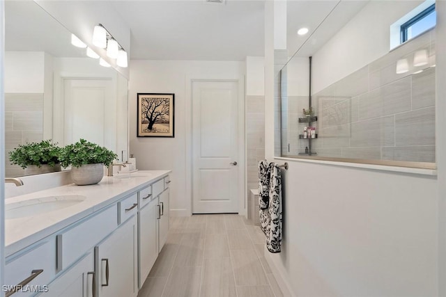 5596 Celebration Dr, Ave Maria, FL 34142 - bathroom featuring double vanity, walk in shower, and recessed lighting