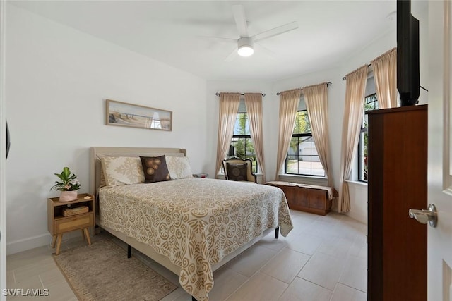 5596 Celebration Dr, Ave Maria, FL 34142 - bedroom featuring multiple windows, ceiling fan, and light tile patterned floors