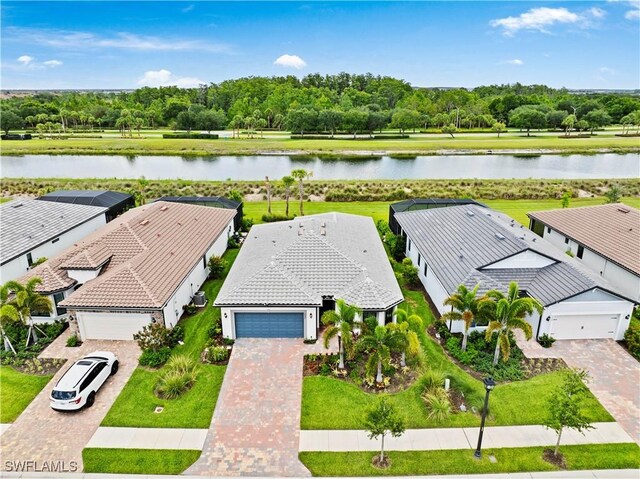 5596 Celebration Dr, Ave Maria, FL 34142 - view from above of property with a large body of water and a tree filled landscape