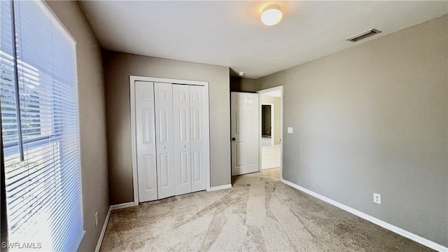 4532/4534 29th St SW, Lehigh Acres, FL 33973 - unfurnished bedroom with light colored carpet, a closet, and baseboards