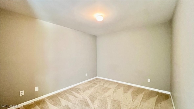 4532/4534 29th St SW, Lehigh Acres, FL 33973 - unfurnished room with baseboards and light carpet