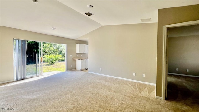4532/4534 29th St SW, Lehigh Acres, FL 33973 - unfurnished living room featuring light colored carpet, vaulted ceiling, and baseboards