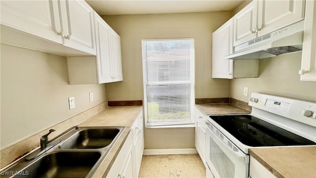 4532/4534 29th St SW, Lehigh Acres, FL 33973 - kitchen featuring white electric range, a sink, under cabinet range hood, and healthy amount of natural light