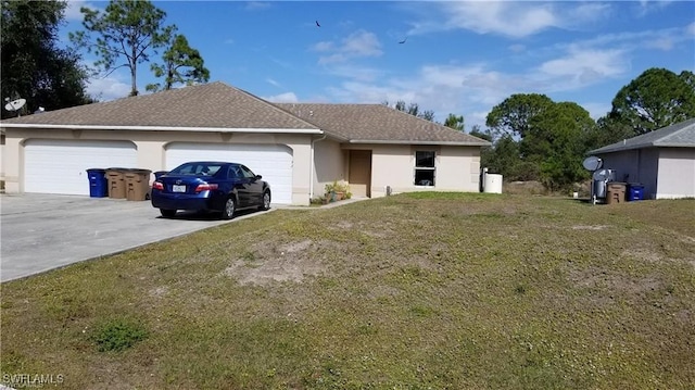 4532/4534 29th St SW, Lehigh Acres, FL 33973 - view of front facade featuring stucco siding, driveway, a front yard, and an attached garage