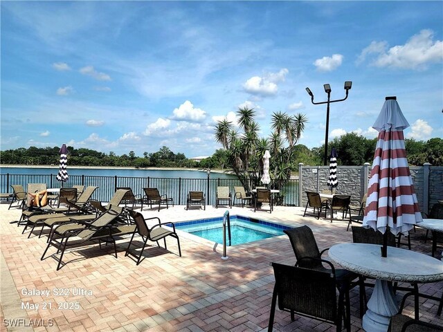 9610 Green Cypress Ln Unit 4, Fort Myers, FL 33905 - view of pool featuring a patio and a water view