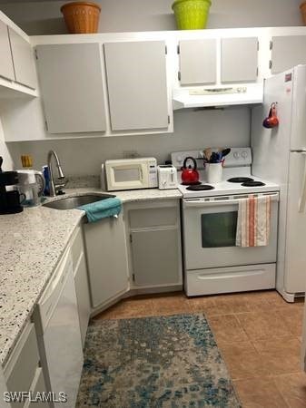 9610 Green Cypress Ln Unit 4, Fort Myers, FL 33905 - kitchen featuring white appliances, under cabinet range hood, a sink, light tile patterned floors, and white cabinets