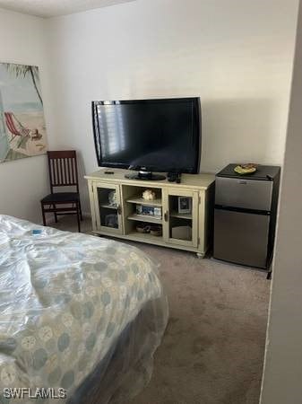 9610 Green Cypress Ln Unit 4, Fort Myers, FL 33905 - carpeted bedroom featuring freestanding refrigerator
