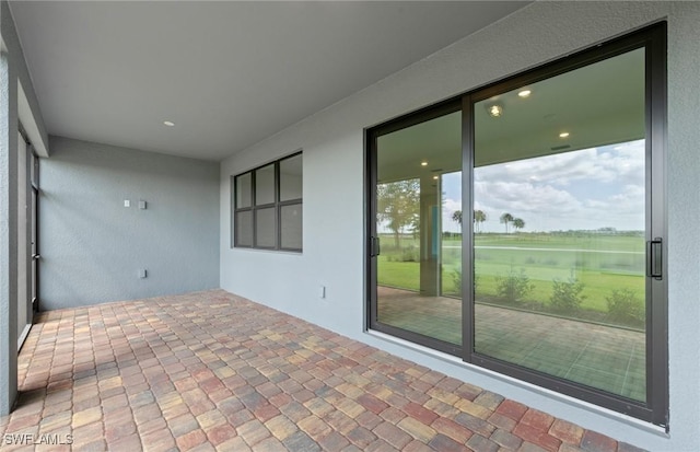 6600 Legacy Way, Ave Maria, FL 34142 - unfurnished sunroom featuring brick flooring and recessed lighting