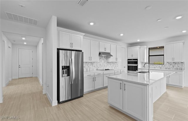 6600 Legacy Way, Ave Maria, FL 34142 - kitchen with black appliances, white cabinets, backsplash, light countertops, and recessed lighting