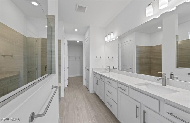 6600 Legacy Way, Ave Maria, FL 34142 - full bath featuring double vanity, a stall shower, a walk in closet, and recessed lighting