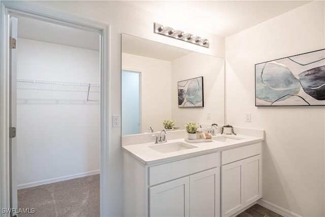 1716 Beach Pkwy W, Cape Coral, FL 33914 - bathroom with double vanity and a walk in closet