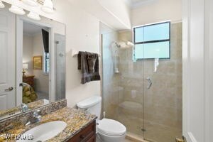 15941 Chance Way, Fort Myers, FL 33908 - ensuite bathroom with toilet, vanity, a shower stall, and crown molding