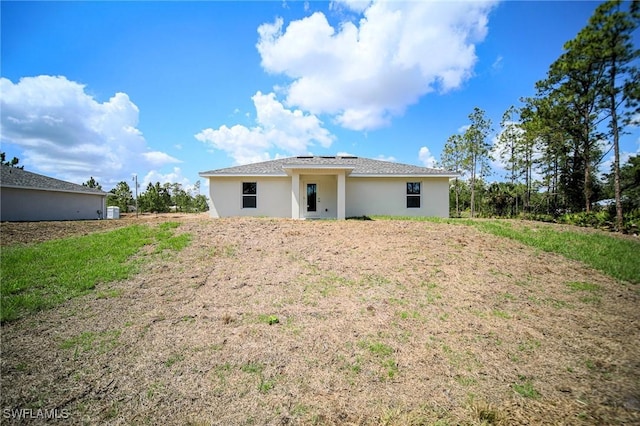 130 Sanborn Dr, Lehigh Acres, FL 33972 - rear view of property with stucco siding
