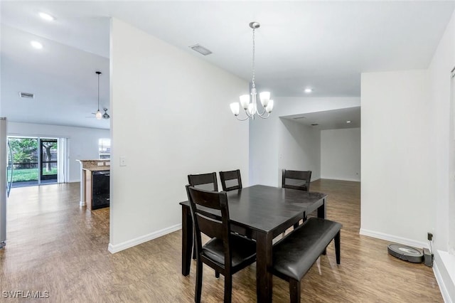1205 SW 32nd Ter, Cape Coral, FL 33914 - dining area with wood finished floors, a chandelier, baseboards, recessed lighting, and vaulted ceiling
