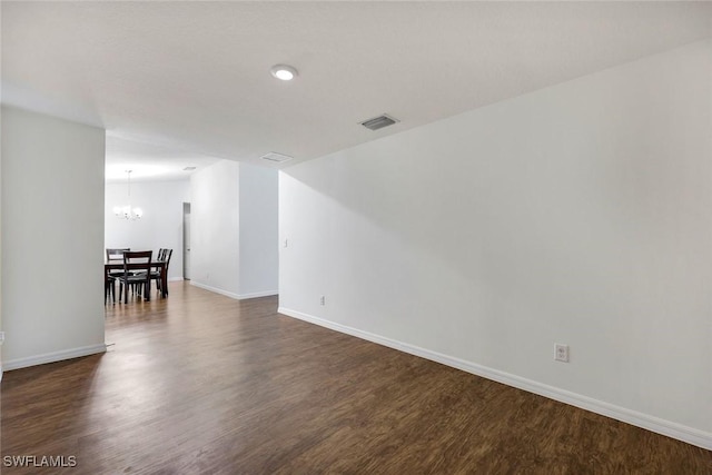 1205 SW 32nd Ter, Cape Coral, FL 33914 - unfurnished room featuring a chandelier, dark wood finished floors, and baseboards