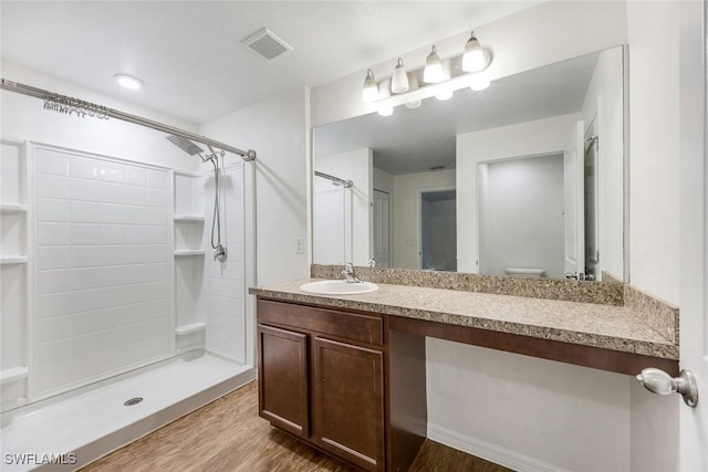 1205 SW 32nd Ter, Cape Coral, FL 33914 - bathroom featuring vanity, wood finished floors, a shower, and toilet