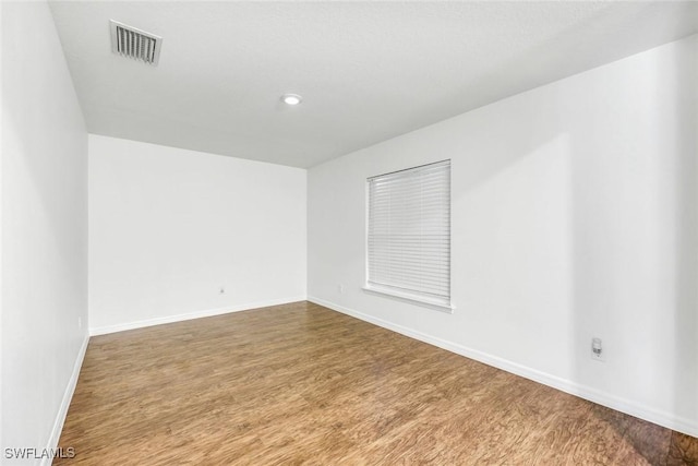 1205 SW 32nd Ter, Cape Coral, FL 33914 - empty room with wood finished floors, baseboards, and recessed lighting