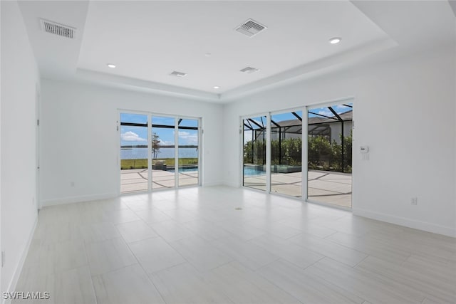 17236 Blue Sapphire Dr, Fort Myers, FL 33913 - unfurnished room with a raised ceiling, baseboards, a sunroom, and recessed lighting