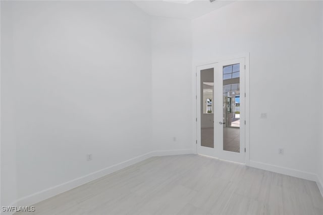 17236 Blue Sapphire Dr, Fort Myers, FL 33913 - empty room with baseboards, a towering ceiling, and french doors