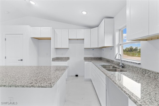 955 Plantation Rd, Lehigh Acres, FL 33974 - kitchen featuring a sink, vaulted ceiling, light stone countertops, white cabinetry, and recessed lighting
