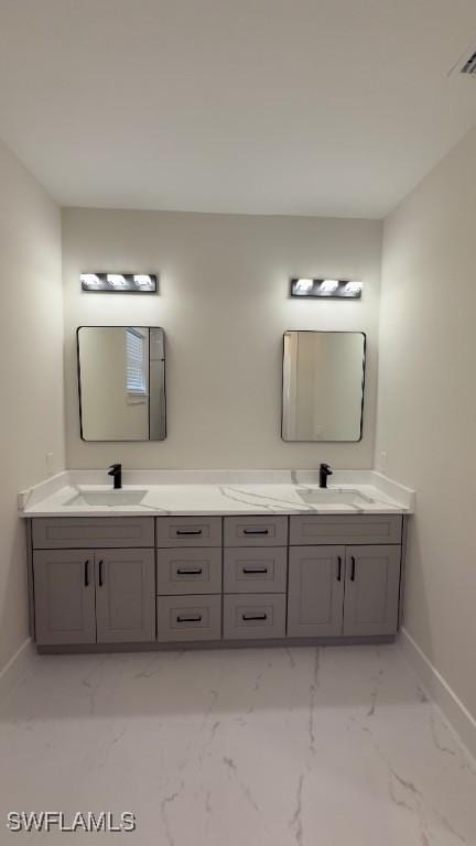 4619 7th St W, Lehigh Acres, FL 33971 - bathroom featuring baseboards, marble finish flooring, and double vanity