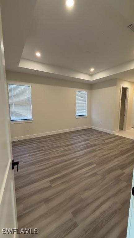 4619 7th St W, Lehigh Acres, FL 33971 - unfurnished room featuring a raised ceiling, wood finished floors, recessed lighting, and baseboards