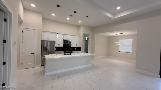4619 7th St W, Lehigh Acres, FL 33971 - kitchen with appliances with stainless steel finishes, a sink, recessed lighting, white cabinets, and a kitchen island with sink