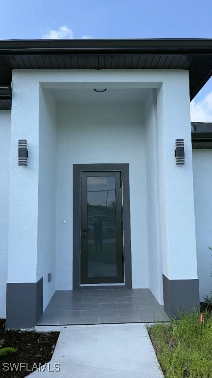 4619 7th St W, Lehigh Acres, FL 33971 - entrance to property featuring stucco siding