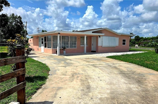 10 E Jersey Rd, Lehigh Acres, FL 33936 - single story home featuring stucco siding and driveway
