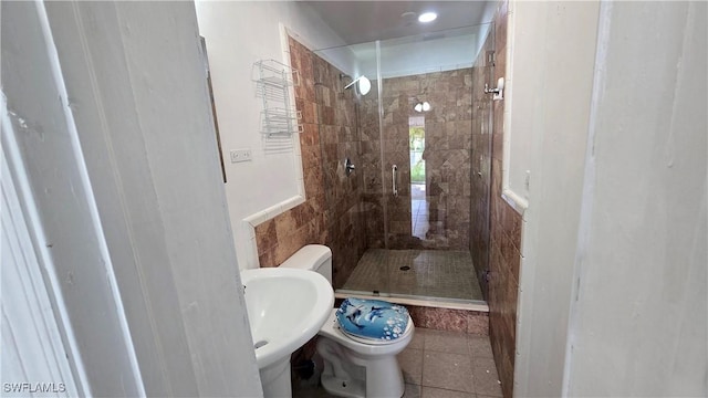 10 E Jersey Rd, Lehigh Acres, FL 33936 - bathroom featuring a shower stall, toilet, tile patterned floors, and a sink